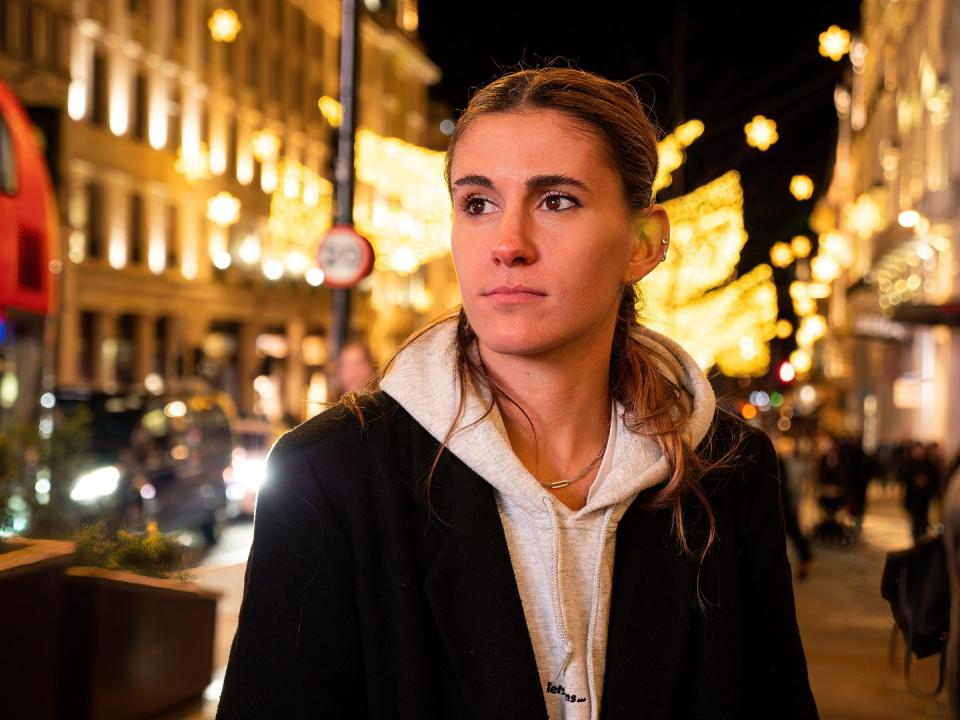 activist zan moon in hollyoaks irl, in a city street at night