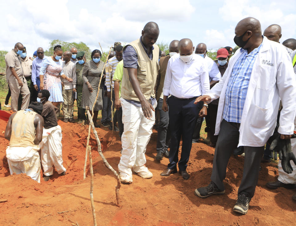 Kenya Interior minister Kithure Kindiki, centre, in white shirt, inspects graves where victims of a Christian Cult are buried at a forest in Shakahola, outskirts of tourist town of Malindi, Coastal Kenya Tuesday, April 25, 2023. Kenya's president William Ruto said Monday that the starvation deaths of dozens of followers of pastor Paul Makenzi, who was arrested on suspicion of telling his followers to fast to death in order to meet Jesus, is akin to terrorism (AP Photo)