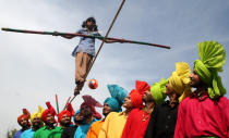 A girl walks on a tightrope during the Festival of Gardens in the northern Indian city of Chandigarh, February 25, 2006. The Festival, intended to encourage people to walk through the Rose Garden to enjoy the beauty of roses, includes performances of music, dance, flower shows and events for children. REUTERS/Ajay Verma