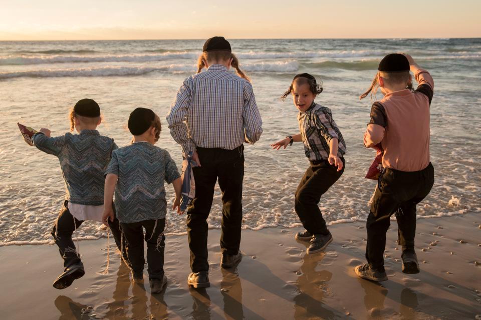 <p>Ultra-Orthodox Jewish boys perform the “Tashlich” ritual along the Mediterranean Sea in the Israeli city of Herzliya, near Tel Aviv, on Sept. 28, 2017, during which “sins are cast into the water to the fish”. The “Tashlich” ritual is performed before the Day of Atonement, or Yom Kippur, the most important day in the Jewish calendar, which in 2017 starts at sunset on Sept. 29. (Photo: Jack Guez/AFP/Getty Images) </p>