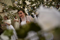 <p>Participants dressed in bridal white surrounded by flowers, takes part in the pilgrimage “The Maidens”, in Sorzano, northern Spain, Sunday, May 21, 2017. According to ancient traditions, the pilgrimage “The Maidens” is in honor of the spring season and the fertility of women. (Photo: Alvaro Barrientos/AP) </p>