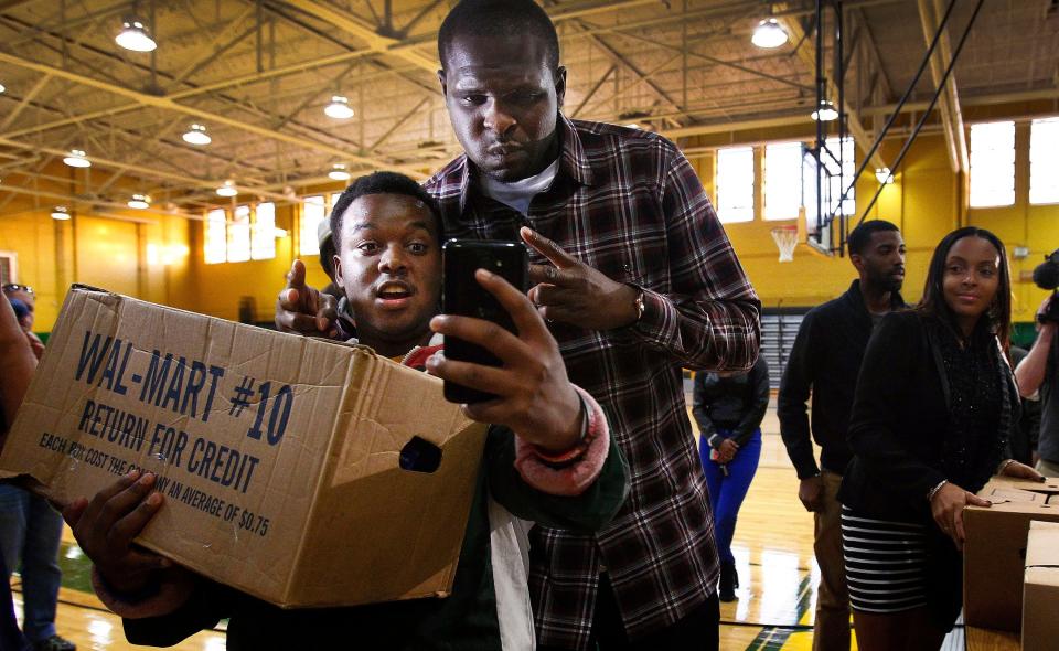 November 11, 2013 - Memphis Grizzlies' Zach Randolph (right) takes a picture with Trent Jones, 17, (left) during his holiday food basket give away at Booker T. Washington High School. Randolph disrupted the food basket to 450 needy families for the upcoming Thanksgiving holiday as part of the Grizzlies' Season of Giving. (Mark Weber/The Commercial Appeal) 