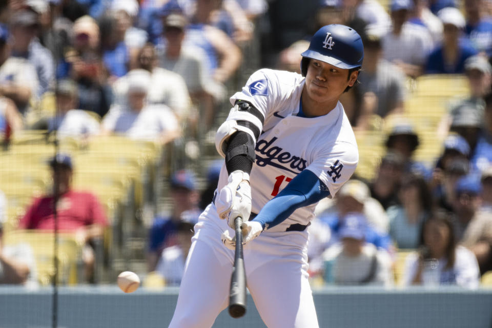 Los Angeles Dodgers' Shohei Ohtani bats during the first inning of a baseball game against the New York Mets in Los Angeles, Sunday, April 21, 2024. (AP Photo/Kyusung Gong)
