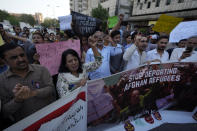 A social group, Aurat March, hold signs during a demonstration against Pakistani government, in Karachi, Pakistan, Sunday, Oct. 29, 2023. Pakistan says it has recently announced plans to deport all migrants who are in the country illegally, including 1.7 million Afghans, who will be implemented in a "phased and orderly manner." (AP Photo/Fareed Khan)