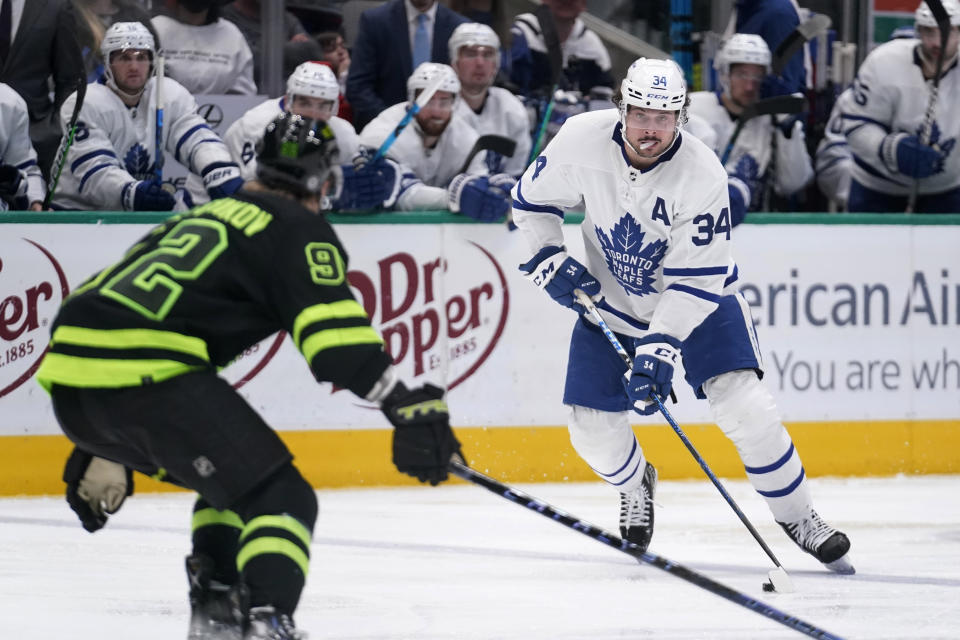 Dallas Stars center Vladislav Namestnikov (92) defends as Toronto Maple Leafs center Auston Matthews (34) handles the puck during the second period of an NHL hockey game Thursday, April 7, 2022, in Dallas. (AP Photo/Tony Gutierrez)