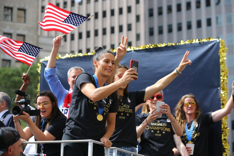 Ali Krieger takes photos of the crowds as the U.S. women's soccer team is celebrated with a parade along the Canyon of Heroes, Wednesday, July 10, 2019, in New York. (Photo: Gordon Donovan/Yahoo News)