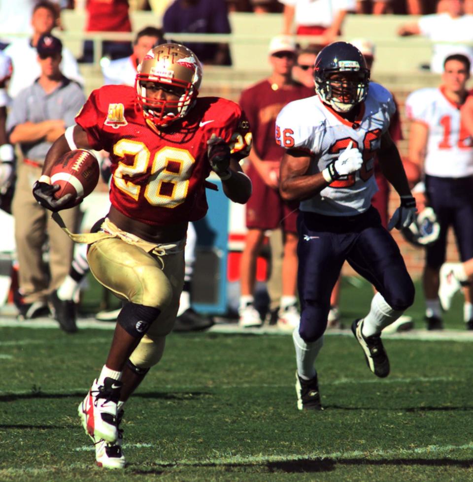 Florida State tailback Warrick Dunn (28) rushes for a touchdown as Virginia's Antwan Harris gives chase during a college football game on October 26, 1996. [Will Dickey/Florida Times-Union]