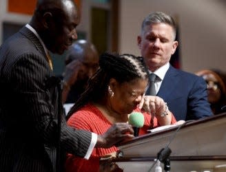 Sabrina Jones, the fiancée of Frank E. Tyson, speaks Thursday at a press conference about his death at St. Paul AME Church. Also shown are attorneys Ben Crump, left, and Bobby DiCello.