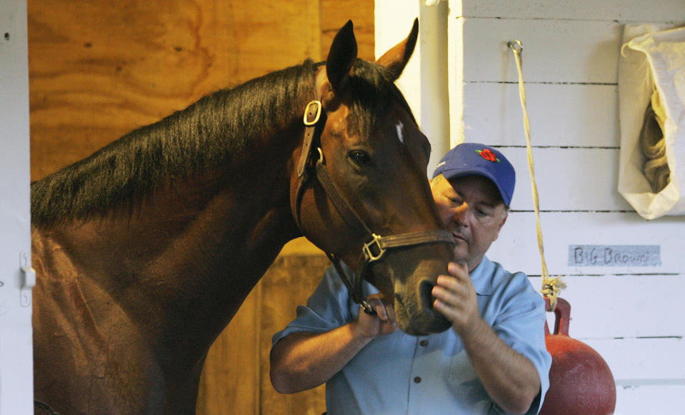 FILE - Big Brown's trainer Rick Dutrow rubs the horse's nose at Churchill Downs on May 2, 2008, in Louisville, Ky. Dutrow, who trained 2008 Kentucky Derby and Preakness winner Big Brown, saddled his first starter on Saturday, May 6, 2023, in his return from a 10-year suspension by New York racing officials. (AP Photo/Ed Reinke, File)