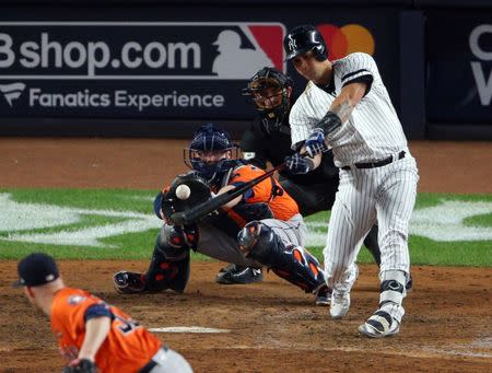 Oct 17, 2017; Bronx, NY, USA; New York Yankees designated hitter Gary Sanchez (24) hits a two RBI double against the Houston Astros during the eighth inning in game four of the 2017 ALCS playoff baseball series at Yankee Stadium. Mandatory Credit: Brad Penner-USA TODAY Sports