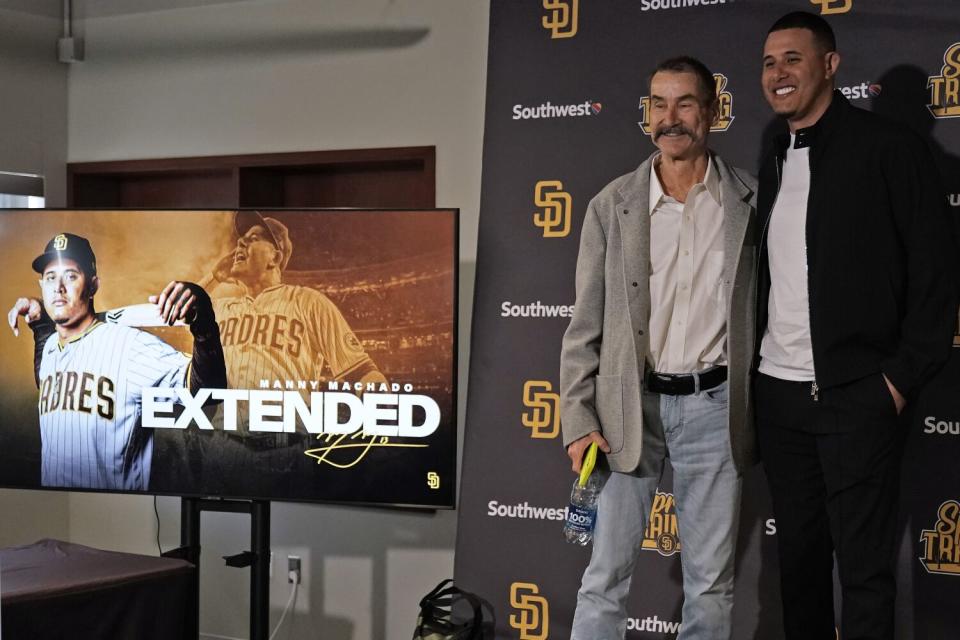 San Diego Padres third baseman Manny Machado poses with owner Peter Seidler after a news conference.