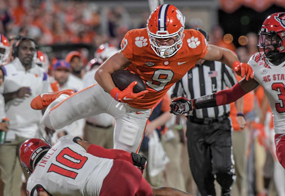 Clemson tight end Jake Briningstool (9) leaps over NC State defensive back Tanner Ingle (10) after catching a pass against NC State during the third quarter at Memorial Stadium in Clemson, South Carolina Saturday, October 1, 2022.  