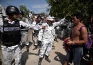 Members of Mexico's National Guard block migrants who crossed the Suchiate river from Tecun Uman, in Guatemala, to Ciudad Hidalgo