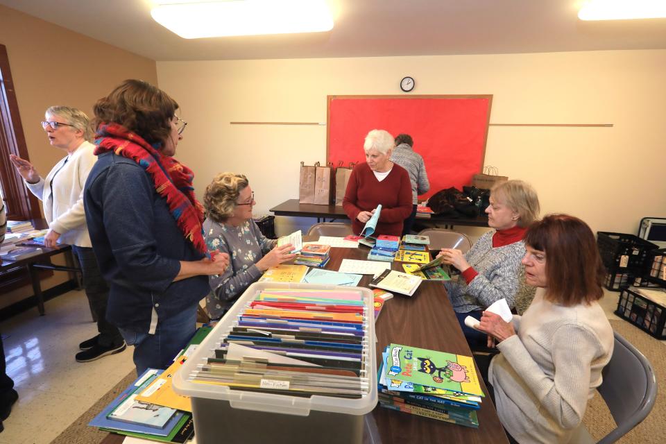 At center, Betty Harrel, development vice president of the Poughkeepsie Branch of the American Association of University Women coordinates with volunteers, from left, Barbara Durniak, Nancy Marrine, Stephanie Pyrek and Gloria Ghedini for their Holiday Helping Hand project, Leading to Reading at the United Methodist Church in Hude Park on November 29, 2023.