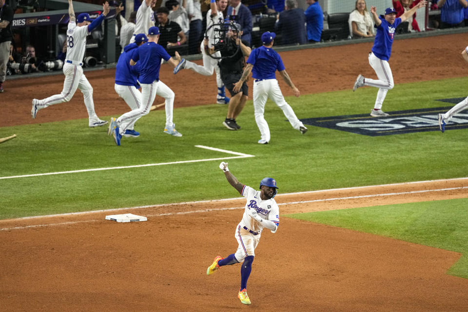 Texas Rangers' Adolis Garcia celebrates after hitting a game-winning home run against the Arizona Diamondbacks during the 11th inning in Game 1 of the baseball World Series Friday, Oct. 27, 2023, in Arlington, Texas. The Rangers won 6-5. (AP Photo/Tony Gutierrez)