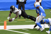 Jacksonville Jaguars running back James Robinson (30) lunges into the end zone for a touchdown during the first half of an NFL football game against the Los Angeles Chargers Sunday, Oct. 25, 2020, in Inglewood, Calif. (AP Photo/Kyusung Gong)