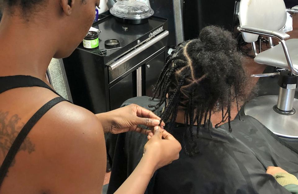 woman braiding hair