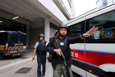 Armed policemen guard the entrance as a prison car carrying British former banker Rurik Jutting enters High Court to launching his appeal, in Hong Kong, China December 12, 2017. REUTERS/Tyrone Siu