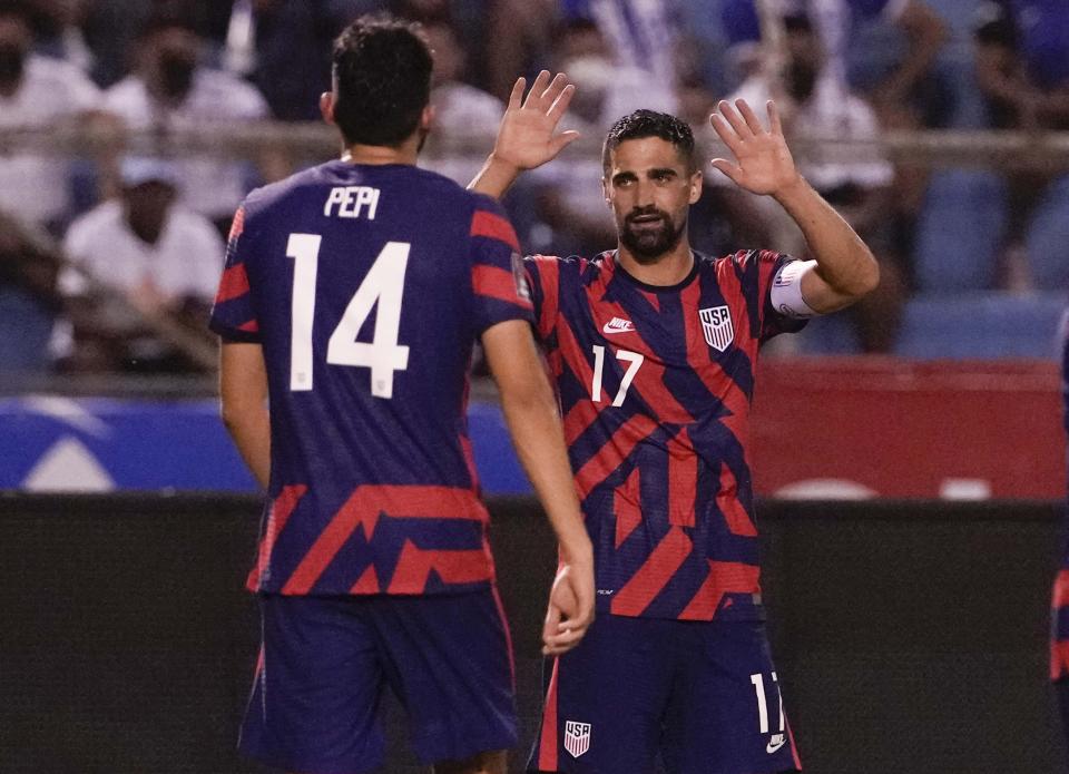 United States' Sebastian Lletget, right, celebrates with his teammate Ricardo Pepi after scoring his side's fourth goal against Honduras during a qualifying soccer match for the FIFA World Cup Qatar 2022, in San Pedro Sula, Honduras, Wednesday, Sept. 8, 2021. (AP Photo/Moises Castillo)