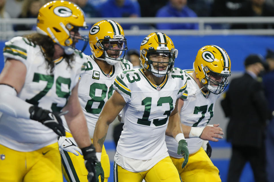 Green Bay Packers wide receiver Allen Lazard (13) runs back the the bench after scoring on a 1-yard pass reception during the first half of an NFL football game against the Detroit Lions, Sunday, Jan. 9, 2022, in Detroit. (AP Photo/Duane Burleson)