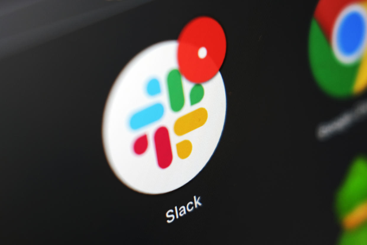 The Slack app icon is displayed on a computer screen.