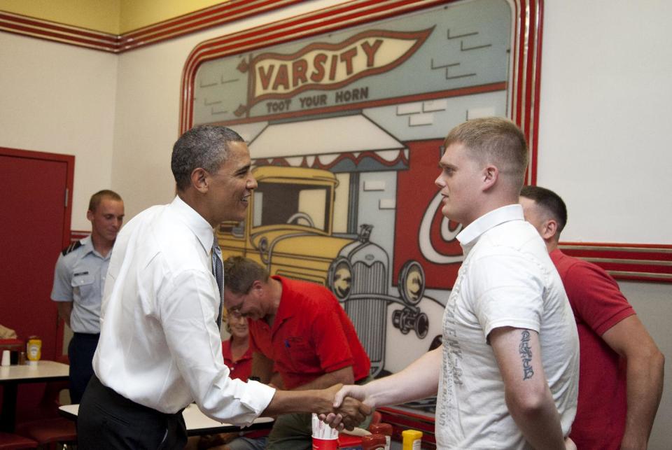 President Barack Obama shakes hands with patrons during his visit to The Varsity restaurant, Tuesday, June 26, 2012, in Atlanta. (AP Photo/Carolyn Kaster)