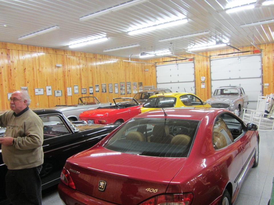 Jim Schlick, left, has a two-level pole barn filled with Peugeots. (Courtesy photo)