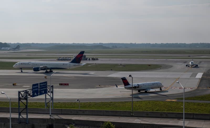 FILE PHOTO: Delta Airlines passenger jets taxi on a runway at Detroit Metropolitan Wayne County Airport in Detroit