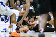 New Orleans Pelicans forward Larry Nance Jr., bottom center, grabs a loose ball against Los Angeles Clippers guard Norman Powell, top center, and center Ivica Zubac, right, during the second half of an NBA basketball game in New Orleans, Friday, March 15, 2024. (AP Photo/Matthew Hinton)