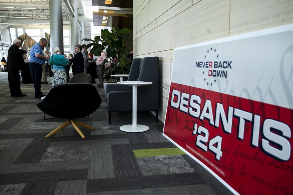 A sign for Florida Gov. Ron DeSantis reading “Never back down” is seen during an Iowa GOP reception, Saturday, May 13, 2023, at The Hotel at Kirkwood Center in Cedar Rapids, Iowa.