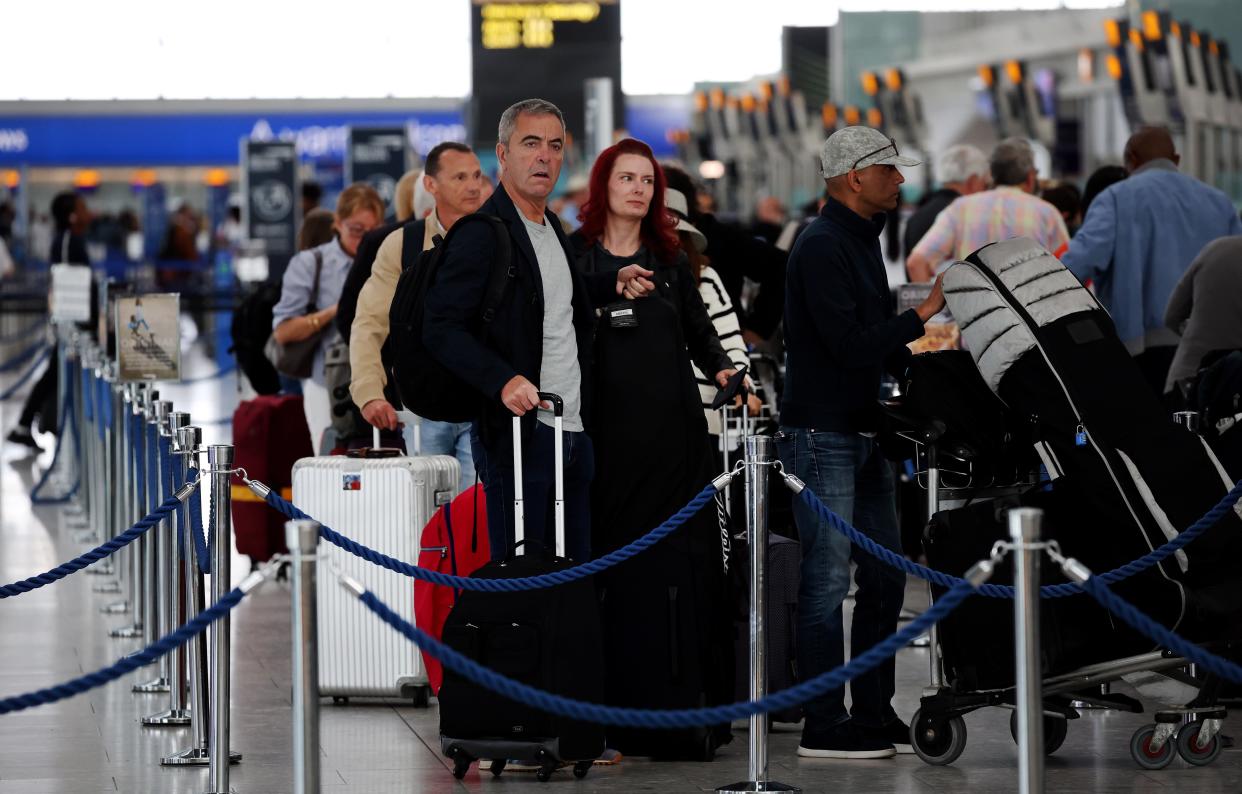 Passengers queue at Heathrow Airport, 30 August 2023 (EPA)