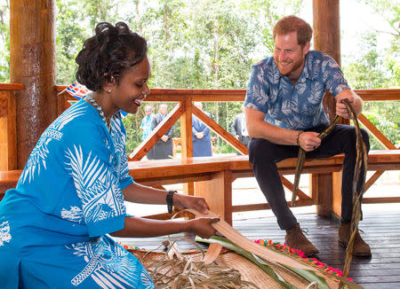 Britain's Prince Harry watches a demonstration of traditional mat weaving as he attends a dedication of the Colo-i-Suva forest to the Queen's Commonwealth Canopy in Suva, Fiji, October 24, 2018. Dominic Lipinski/Pool via REUTERS