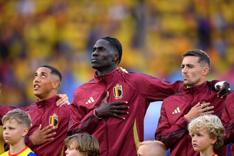 Youri Tielemans, Amadou Onana and Timothy Castagne of Belgium stand for the national anthem prior to the UEFA EURO 2024 group stage match between Belgium and Romania at Cologne Stadium on June 22, 2024