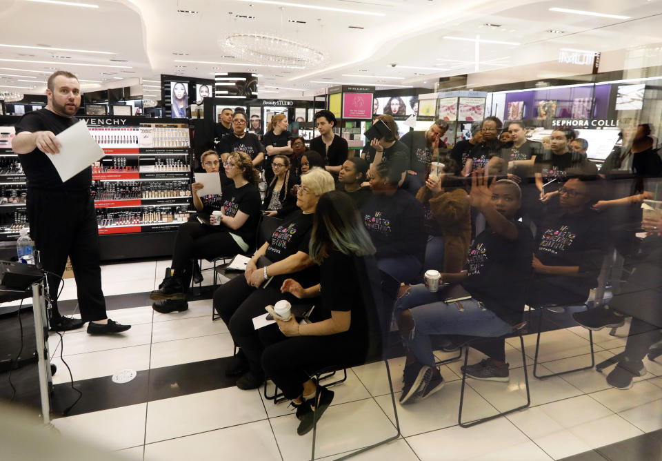 Sephora employees gather in one of the company's closed stores, in New York, Wednesday, June 5, 2019. Sephora is closing its U.S. stores for an hour Wednesday to host inclusion workshops for its employees, just over a month after R&B star SZA said she had security called on her while shopping at a store in California. (AP Photo/Richard Drew)