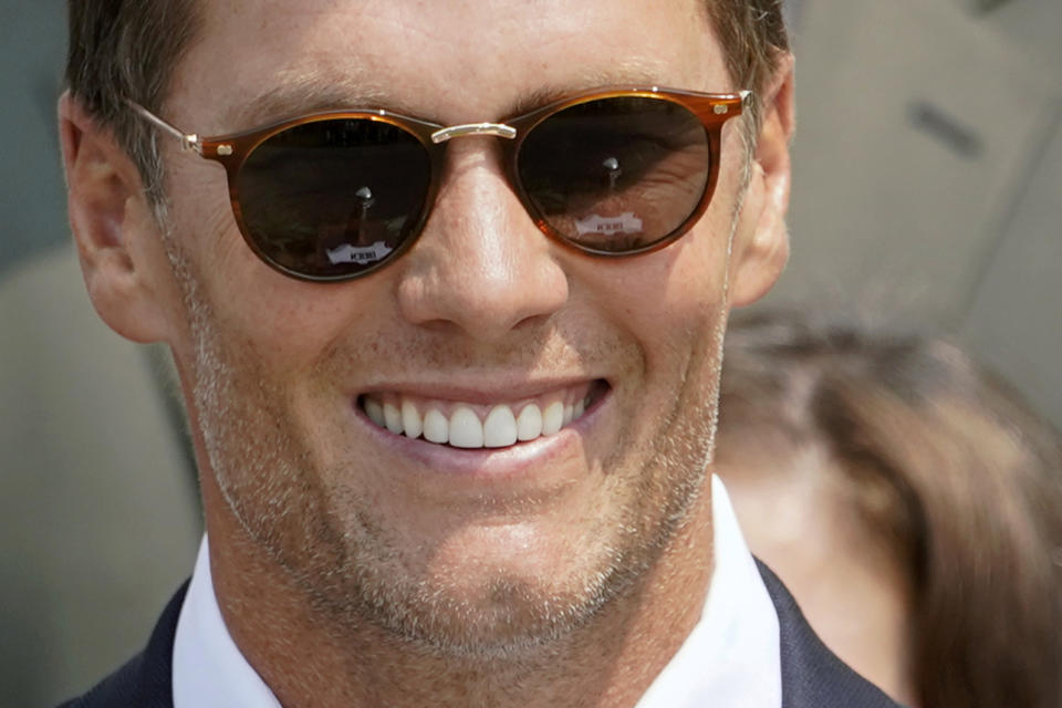 The Vince Lombardi Trophy is reflected in Tampa Bay Buccaneers quarterback Tom Brady's glasses as attends a ceremony on the South Lawn of the White House, in Washington, Tuesday, July 20, 2021, where President Joe Biden honored the Super Bowl Champion Tampa Bay Buccaneers for their Super Bowl LV victory. (AP Photo/Andrew Harnik)