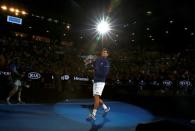 Serbia's Novak Djokovic walks with the men's singles trophy after winning his final match against Britain's Andy Murray at the Australian Open tennis tournament at Melbourne Park, Australia, January 31, 2016. REUTERS/Thomas Peter