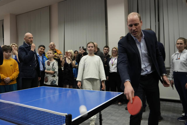 Britain's Prince William plays a game of table tennis as he visits an accommodation centre, for Ukrainians who fled the war, in Warsaw, Poland, Wednesday, March 22, 2023. (AP Photo/Czarek Sokolowski)