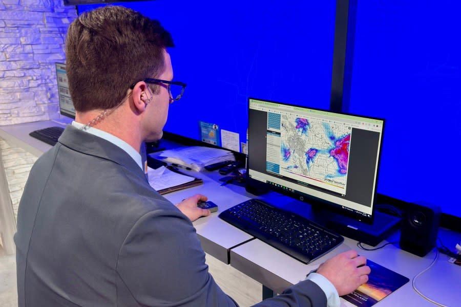 KSNF-TV 16 Meteorologist, Chase Bullman studies a forecast model.