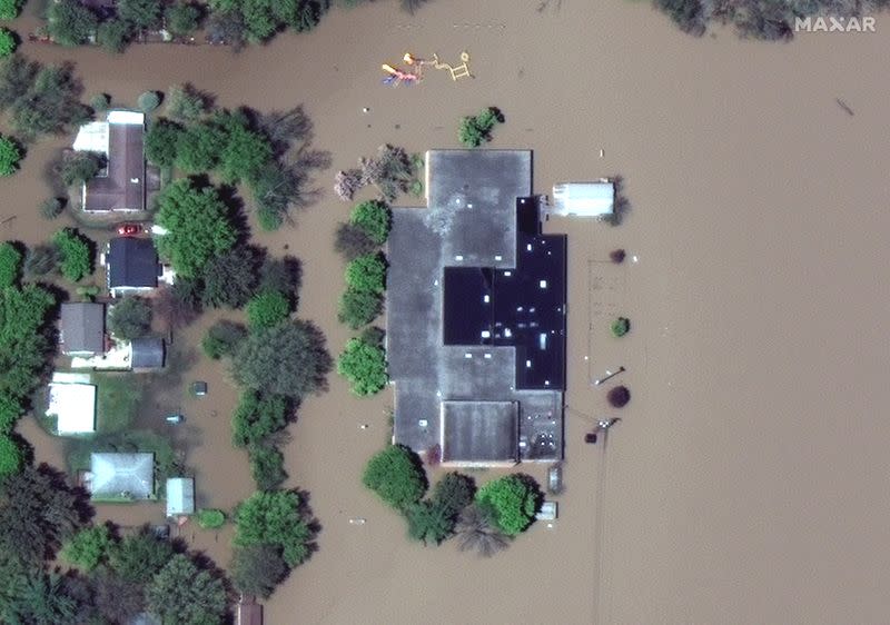 A satellite image shows a flooded Windover High School after rising floodwaters unleashed by two dam failures submerged parts of Midland, Michigan