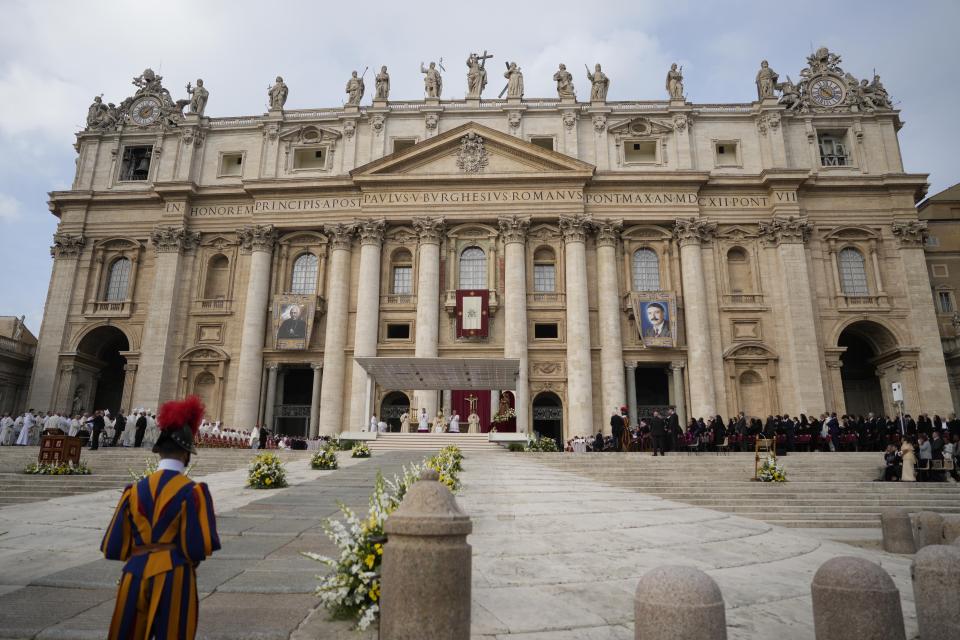 Pope Francis, background center, celebrates a mass for the canonization of two new saints, Giovanni Battista Scalabrini and Artemide Zatti, in St. Peter's Square at the Vatican, Sunday, Oct. 9, 2022. (AP Photo/Andrew Medichini)