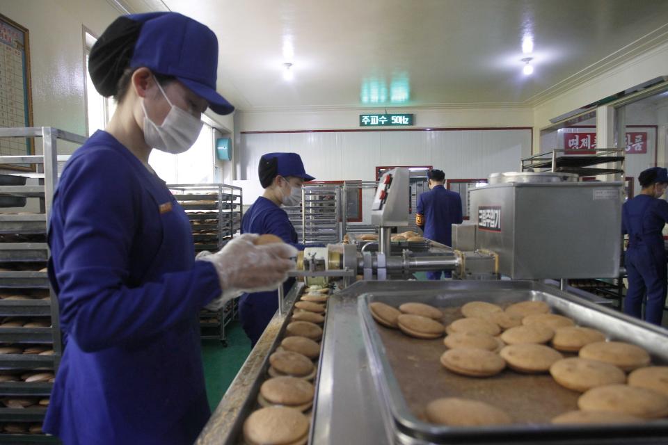 FILE - In this Oct. 28, 2020, file photo, employees oversee the production of snacks at the Songdowon General Foodstuff Factory in Wonsan, Kangwon Province, North Korea. North Korea is staging an “80-day battle,” a propaganda-heavy productivity campaign meant to bolster its internal unity and report greater production in various industry sectors ahead of a ruling party congress in January. (AP Photo/Jon Chol Jin, File)