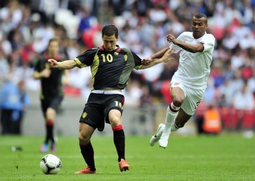 Belgium's Eden Hazard (L) fights for the ball with England's Ashley Cole during their international friendly match at Wembley Stadium in London. England won 1-0