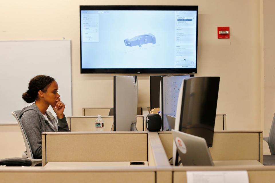 Patricia Pires-Dias, a software engineer, works on back-end coding at the new ProtoXYZ offices at the DeMello International Center on Union Street in New Bedford.