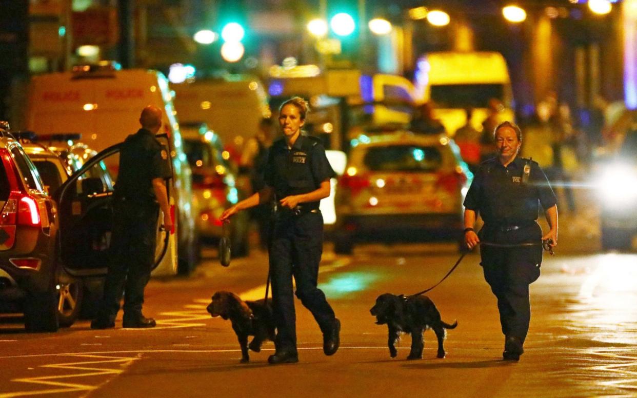 Police officers attend to the scene after a vehicle collided with pedestrians in Finsbury Park - REUTERS