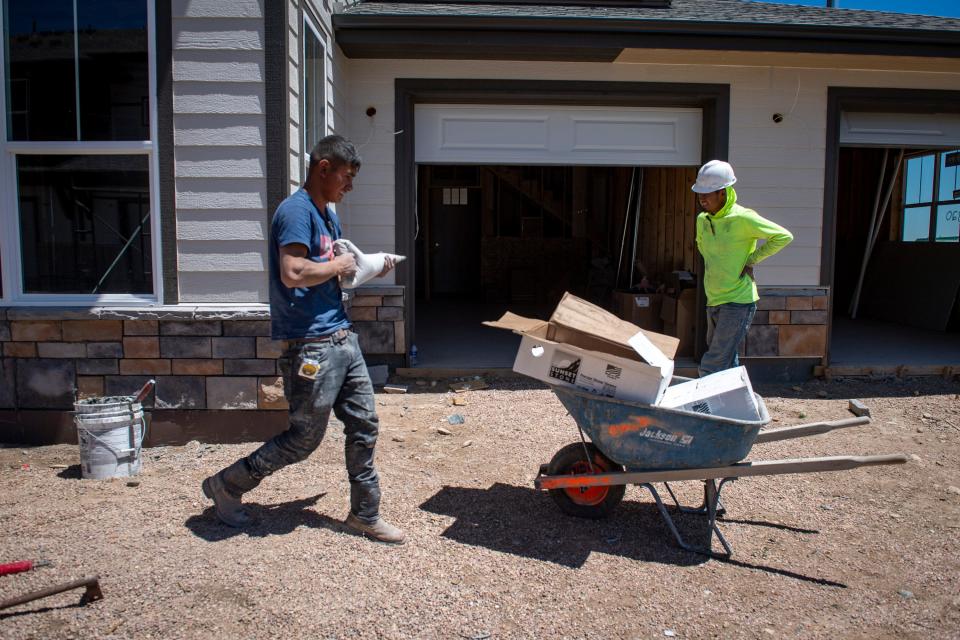 Workers install stone siding on a home in the Northfield development off East Suniga Road in Fort Collins in this file photo.