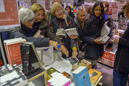 The final copy of French writer Patrick Modiano's book "L'herbe des nuits" is snatched from a table at a bookstore, minutes after Modiano was declared the winner of the 2014 Nobel Prize for Literature, in Stockholm October 9, 2014. REUTERS/Henrik Montgomery/TT News Agency