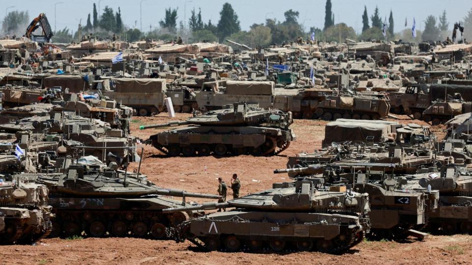 PHOTO: Israeli soldiers walk next to military vehicles near the Israel-Gaza border, amid the ongoing conflict between Israel and the Palestinian Islamist group Hamas, in southern Israel, May 8, 2024. (Ammar Awad/Reuters)