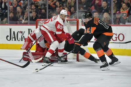 Feb 16, 2019; Philadelphia, PA, USA; Detroit Red Wings defenseman Danny DeKeyser (65) keeps his eye on the puck as Philadelphia Flyers center Sean Couturier (14) attempts to shoot during the 2nd period of the game against the Philadelphia Flyers at the Wells Fargo Center. Mandatory Credit: John Geliebter-USA TODAY Sports