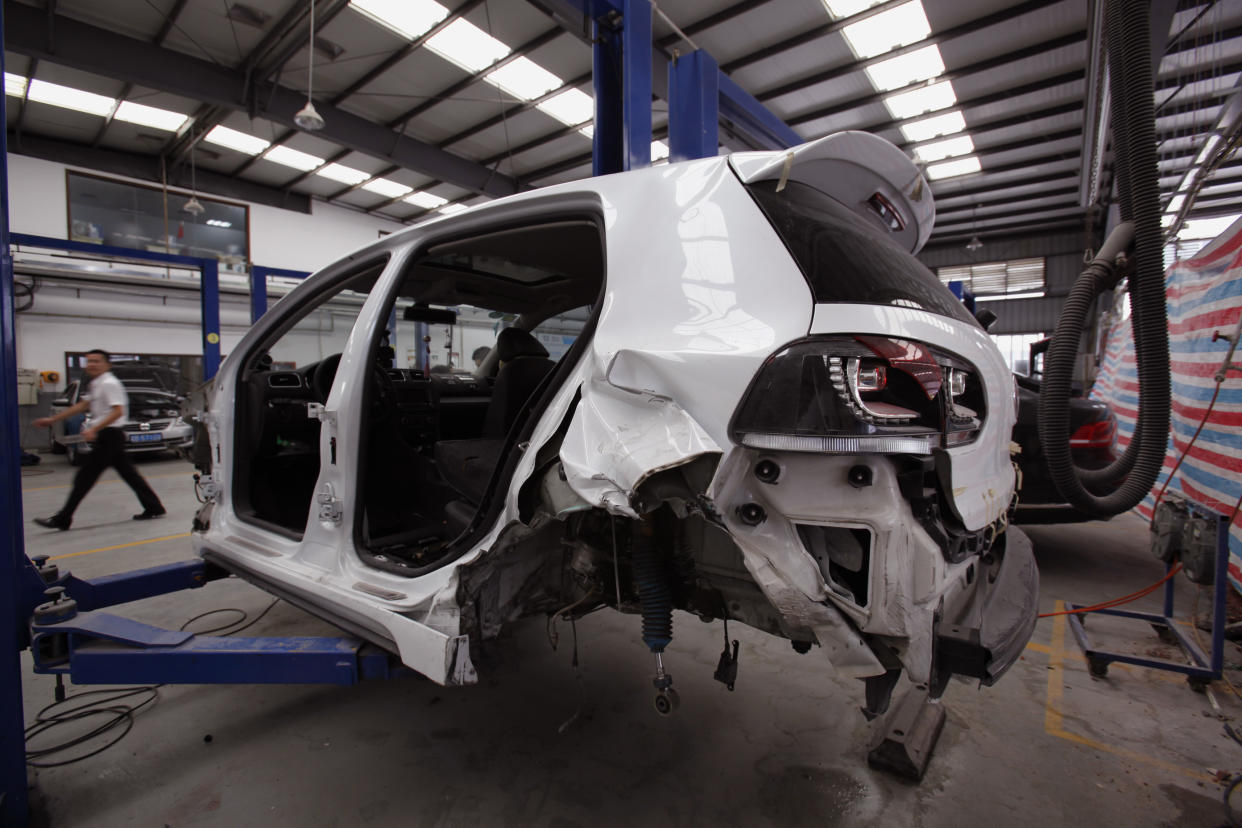 car insurance A crashed car is under repaired at a service centre in Shenzhen May 28, 2012. A rule change in May granted foreign insurers in China the right to sell a type of mandatory car insurance. Picture taken May 28, 2012. To match Analysis CHINA-AUTOINSURANCE/         REUTERS/Bobby Yip (CHINA - Tags: BUSINESS TRANSPORT)