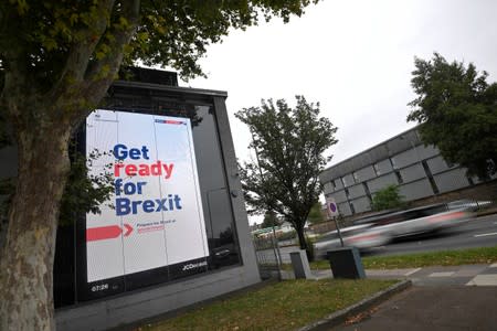 An electronic billboard displays a British government Brexit information awareness campaign advertisement in west London